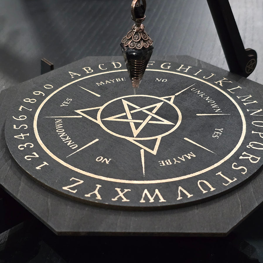 Unique engraved pendulum board in black wood.