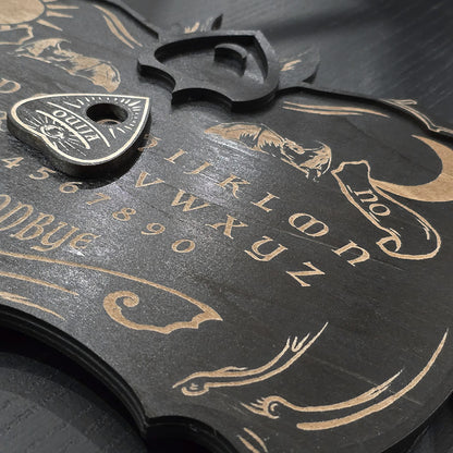 Unique black ouija board engraved and cut into wood. 