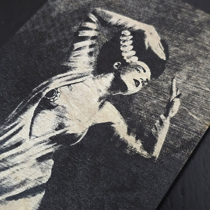 Black wooden box with bride of Frankenstein engraved on a dark surface