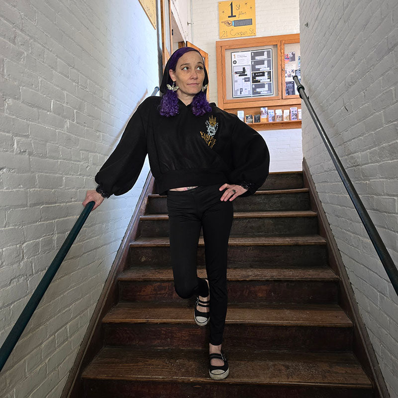 Model in a custom black fleece pullover hoodie with a vampire tech graphic on the front. 